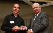 man presenting award